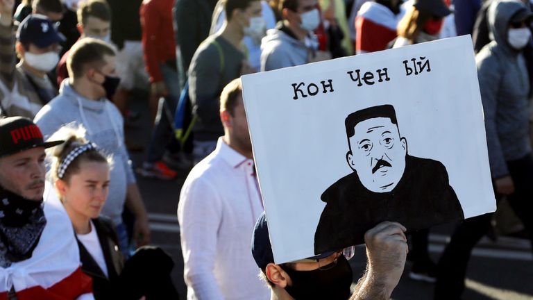 A man carries a placard depicting Belarus' President as North Korean leader Kim Jong-un and reading "Washed-up" during a demonstration called by opposition movement for an end to the regime of authoritarian leader in Minsk on September 20, 2020 - Belarus President Alexander Lukashenko, who has ruled the ex-Soviet state for 26 years, claimed to have defeated opposition leader Svetlana Tikhanovskaya with 80 percent of the vote in the August 9, elections. (Photo by - / TUT.BY / AFP) (Photo by -/TUT