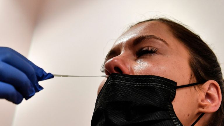 A woman has sample taken for a PCR test to screen for Covid-19 (novel coronavirus) at the Eylau Unilabs analysis laboratory in Neuilly-sur-Seine, outside Paris, on September 15, 2020. - With the rising number of Covid-19 infections and a high demand by the public to be tested, French analysis laboratories are saturated. The Eylau Unilabs laboratory has set up a team who relay around the clock to carry out PCR Covid-19 screenings, averaging around 2000 tests per day. (Photo by ALAIN JOCARD / AFP) (Photo by ALAIN JOCARD/AFP via Getty Images)